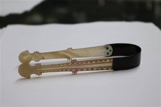 A pair of George III mother of pearl and tortoiseshell sugar tongs